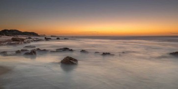 Assaf Frank - Sunset on rocky beach with colorful sky