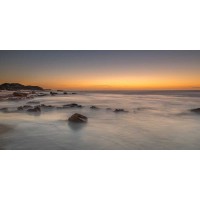 Assaf Frank - Sunset on rocky beach with colorful sky